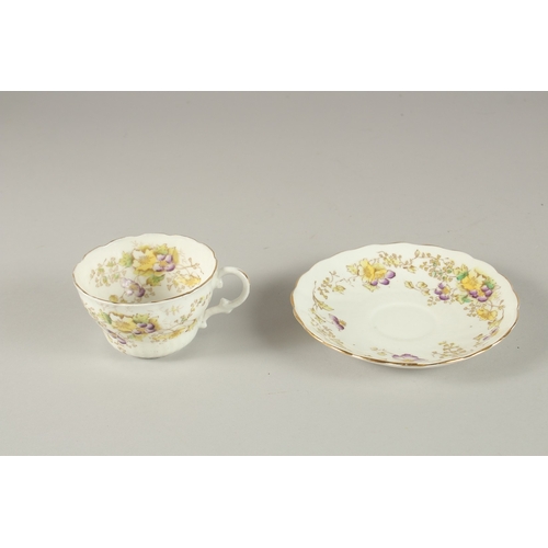 596 - AN AMUSING FLORAL CUP AND SAUCER, painted to the bottom of the cup 