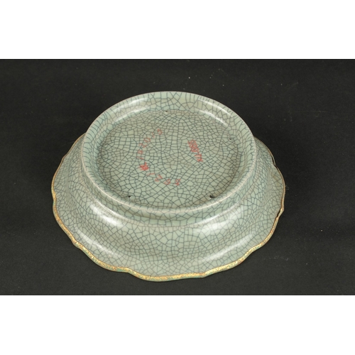 616 - A CELADON CRACKLE GLAZE PETAL FORM DISH, with gilt characters. 19cms wide.