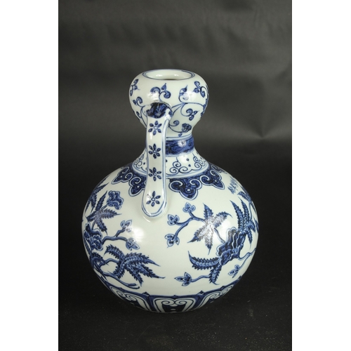 631 - A CHINESE BLUE AND WHITE TWIN-HANDLE DOUBLE GOURD VASE. 23cms high.