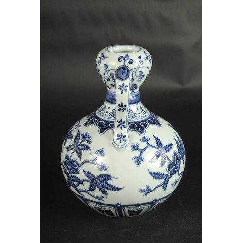 631 - A CHINESE BLUE AND WHITE TWIN-HANDLE DOUBLE GOURD VASE. 23cms high.