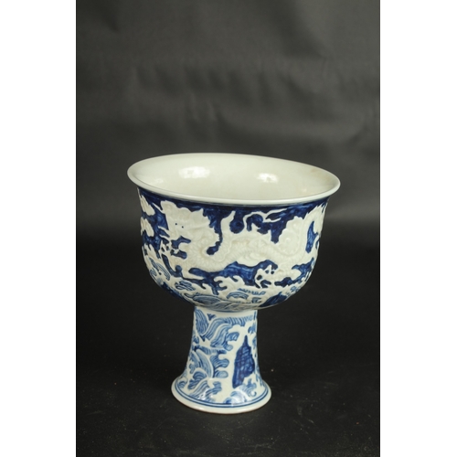 635 - A CHINESE BLUE AND WHITE CARVED DRAGON STEM CUP. 17.5cms high.