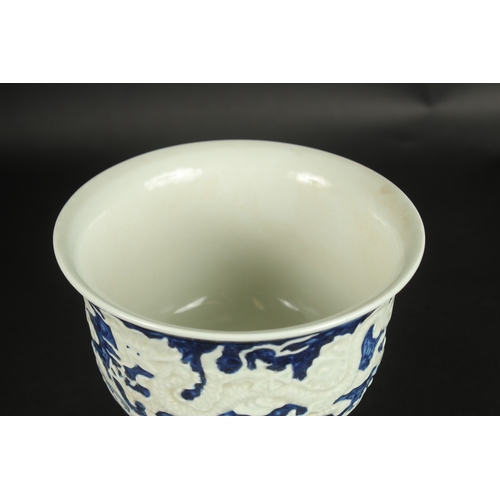 635 - A CHINESE BLUE AND WHITE CARVED DRAGON STEM CUP. 17.5cms high.