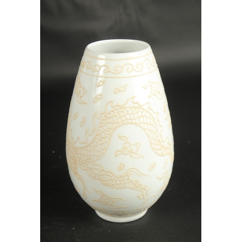 640 - A CHINESE PALE CELADON PORCELAIN DRAGON VASE. 23cms high.