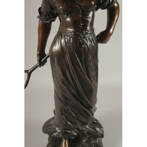 661 - EDOUARD DROUOT (1859-1945) FRENCH A SUPERB LARGE BRONZE OF A YOUNG LADY holding a hay fork. The two-... 