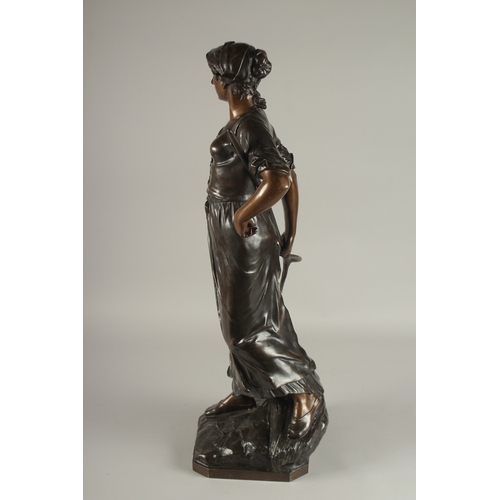 661 - EDOUARD DROUOT (1859-1945) FRENCH A SUPERB LARGE BRONZE OF A YOUNG LADY holding a hay fork. The two-... 