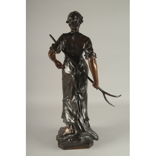 661 - EDOUARD DROUOT (1859-1945) FRENCH A SUPERB LARGE BRONZE OF A YOUNG LADY holding a hay fork. The two-... 