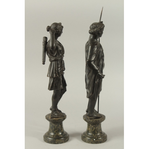 665 - GRAND TOUR BRONZES. A VERY GOOD PAIR OF CLASSICAL BRONZE FIGURES of a man carrying a staff and a you... 