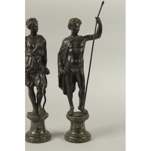 665 - GRAND TOUR BRONZES. A VERY GOOD PAIR OF CLASSICAL BRONZE FIGURES of a man carrying a staff and a you... 