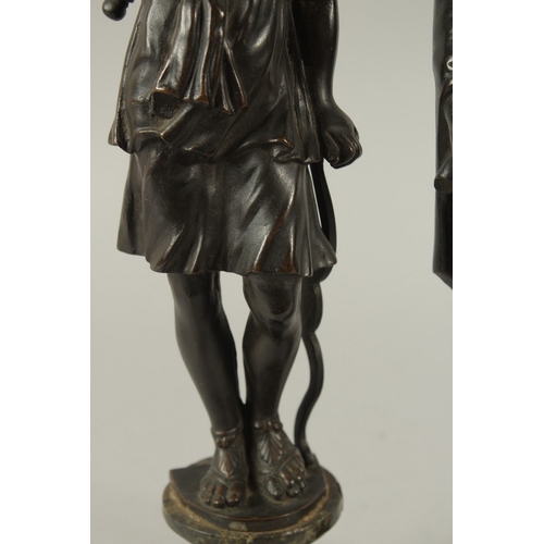 665 - GRAND TOUR BRONZES. A VERY GOOD PAIR OF CLASSICAL BRONZE FIGURES of a man carrying a staff and a you... 