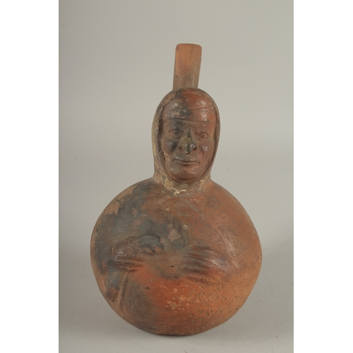 675 - A SOUTH AMERICAN POTTERY VESSEL, modelled as a man. 22cms high.