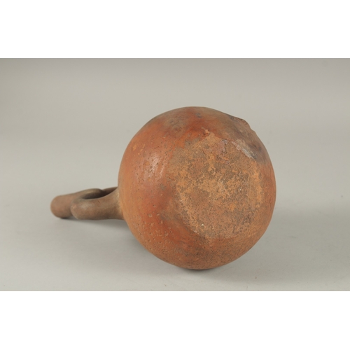 675 - A SOUTH AMERICAN POTTERY VESSEL, modelled as a man. 22cms high.