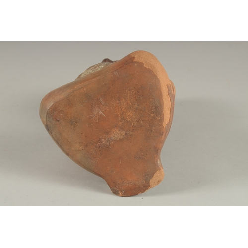 676 - A SOUTH AMERICAN POTTERY VESSEL, modelled as a seated figure (faults). 22cms high.