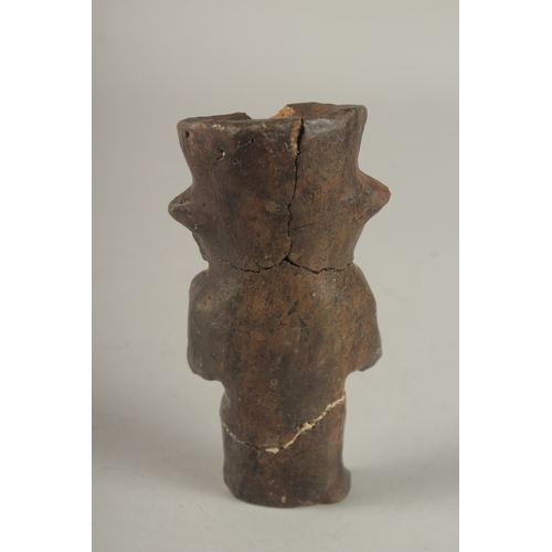 677 - A SMALL SOUTH AMERICAN POTTERY FIGURE. 15cms high.