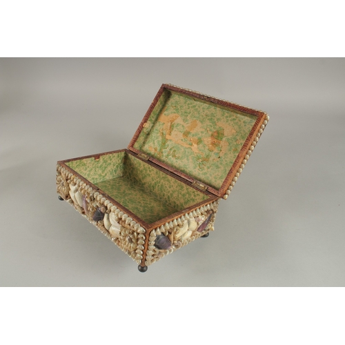 682 - A DECORATIVE VICTORIAN SHELL ENCRUSTED CASKET. 24cms long.