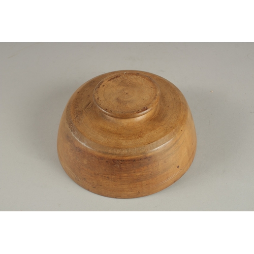 694 - A CARVED WOOD BOWL SHAPE BUTTER PAT. 18cms diameter.