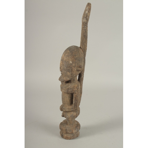 698 - A CARVED WOOD TRIBAL FIGURE OF A STANDING MALE. 40cms high.