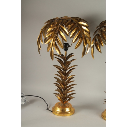 726 - A PAIR OF GILT METAL PALM TREE LAMPS. 29ins high.