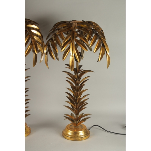 726 - A PAIR OF GILT METAL PALM TREE LAMPS. 29ins high.