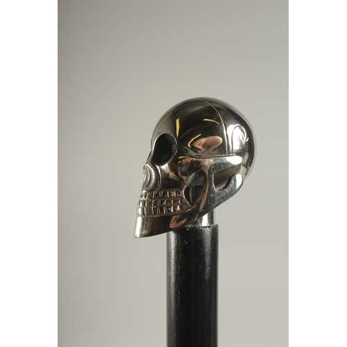 732 - A WOODEN WALKING STICK WITH SKULL HANDLE.