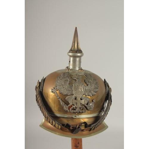 795 - A PRUSSIAN BRASS HELMET stamped JENOKERS, with large metal badge. Eagle F. R. 1813, with spike and c... 