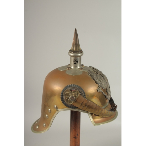 795 - A PRUSSIAN BRASS HELMET stamped JENOKERS, with large metal badge. Eagle F. R. 1813, with spike and c... 