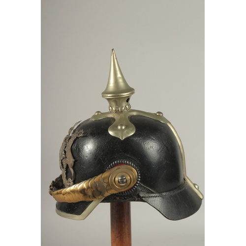 796 - A PRUSSIAN BRASS AND LEATHER HELMET with spike, metal badge FURCUTLOS UND TREU, with chin strap. Pur... 