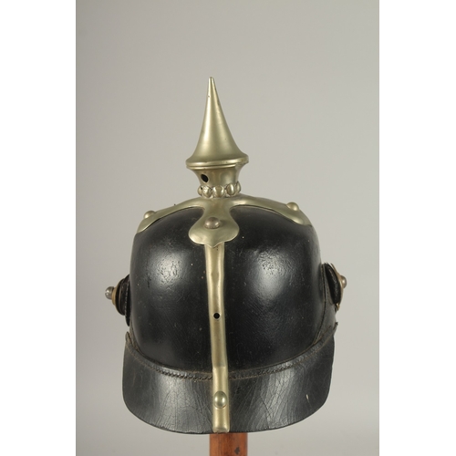 796 - A PRUSSIAN BRASS AND LEATHER HELMET with spike, metal badge FURCUTLOS UND TREU, with chin strap. Pur... 