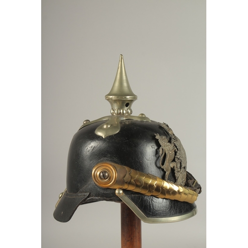 796 - A PRUSSIAN BRASS AND LEATHER HELMET with spike, metal badge FURCUTLOS UND TREU, with chin strap. Pur... 