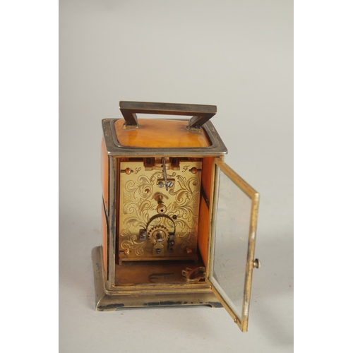 833 - A RARE VICTORIAN SILVER AND AMBER CLOCK, 4ins high, the silver case set with amber panels and precio... 