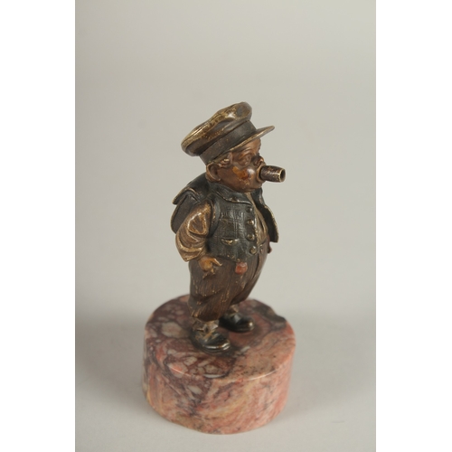 834 - A RARE BERGMANN BRONZE LIGHTER as a small Dutch boy smoking a cheroot and standing on a circular mar... 