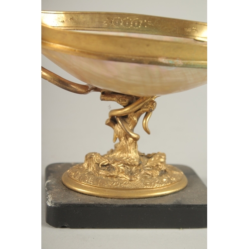 835 - A GRAND TOUR MOTHER-OF-PEARL and GILT METAL TWO HANDLED TAZZA, on a marble base with snake handles. ... 