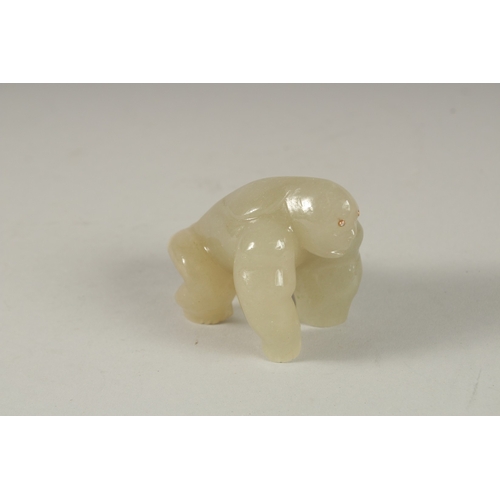 876 - A RUSSIAN CARVED JADE GORILLA with diamond eyes. 3ins, in a fitted box.