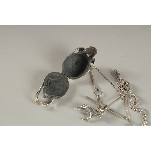 890 - A SILVER SKULL on a chain.