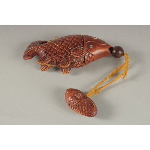 891 - A CARVED HARDWOOD FISH INRO. 4.5ins long.