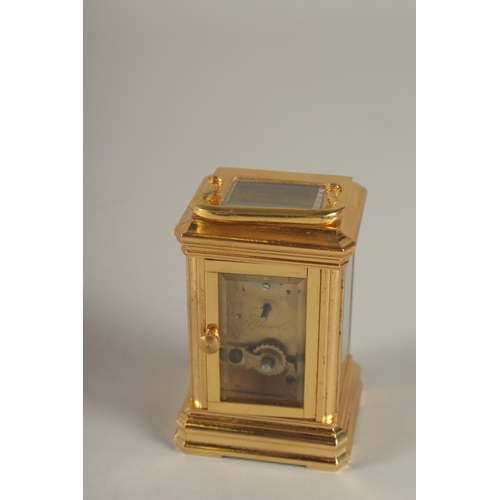 893 - A MINIATURE BRASS CARRIAGE CLOCK. 3.5ins high.