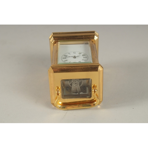 893 - A MINIATURE BRASS CARRIAGE CLOCK. 3.5ins high.