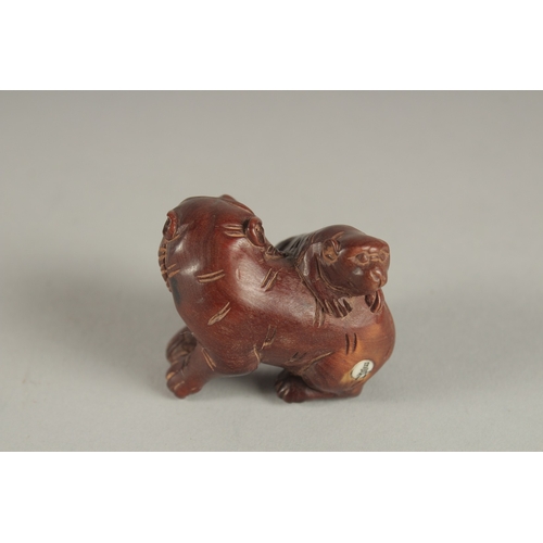 910 - A CARVED JADE DOG OF FO. Signed. 1.5ins.