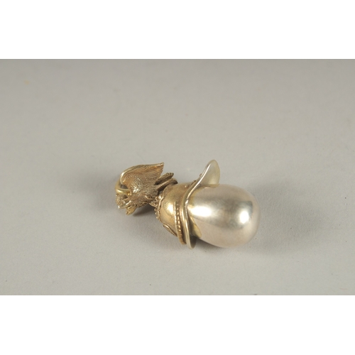 943 - A SILVER HELMET EGG PENDANT.