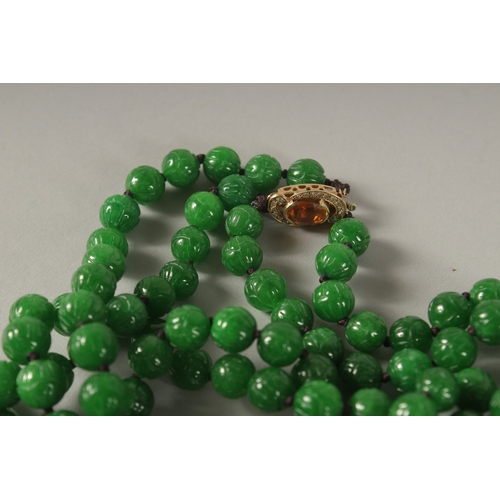 954 - A SUPERB JADE BEAD NECKLACE with diamond, gold and citrine clasp.