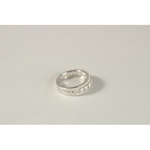 981 - AN 18CT WHITE GOLD AND DIAMOND HALF HOOP RING.