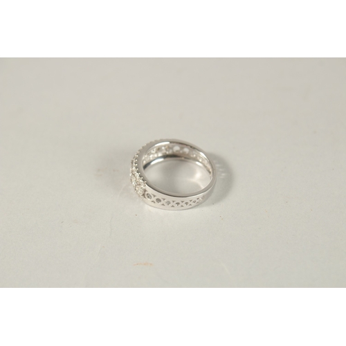 981 - AN 18CT WHITE GOLD AND DIAMOND HALF HOOP RING.