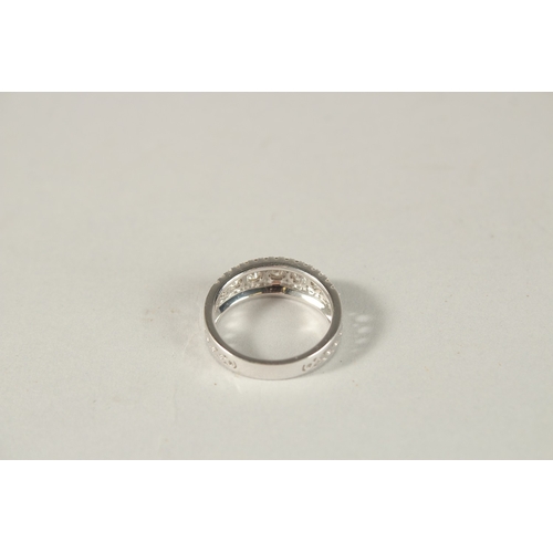 981 - AN 18CT WHITE GOLD AND DIAMOND HALF HOOP RING.