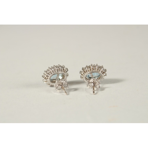 986 - A PAIR OF 18CT WHITE GOLD, AQUAMARINE AND DIAMOND DUAL CLUSTER EAR STUDS, approx. 14mms x 12mms.