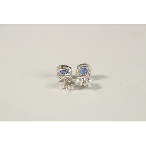 989 - A PAIR OF 18CT WHITE GOLD, SAPPHIRE AND DIAMOND STUD EARRINGS.