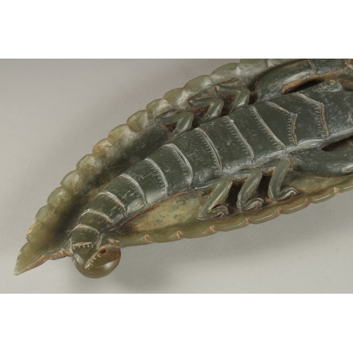 11 - A GREEN SOAPSTONE CARVING, of leaf form with large insect to centre, 26cm long.