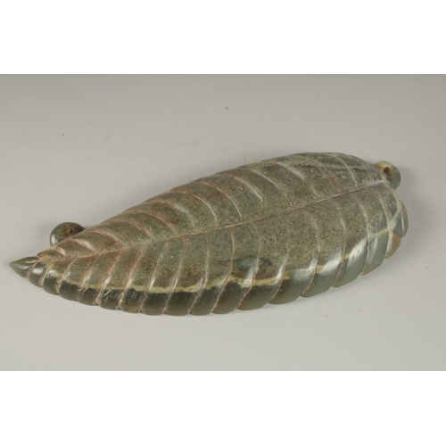 11 - A GREEN SOAPSTONE CARVING, of leaf form with large insect to centre, 26cm long.