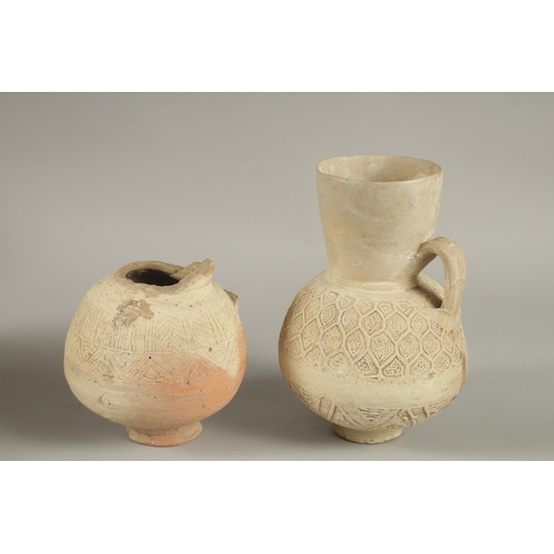 123 - TWO 12TH-13TH CENTURY SELJUK ANAATOLIAN UNGLAZED POTTERY JUGS, one signed, made by Rafi, largest 22c... 