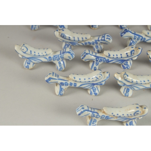 13 - A COLLECTION OF CHINESE BLUE AND WHITE PORCELAIN BRUSH RESTS / CHOPSTICK RESTS, (qty).