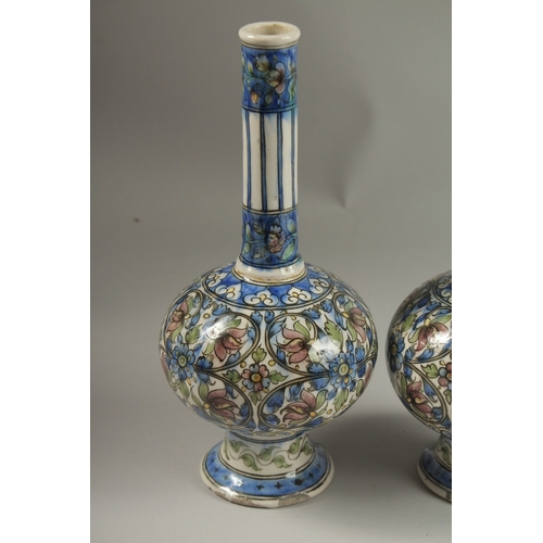 135 - A FINE PAIR OF 19TH CENTURY PERSIAN QAJAR GLAZED POTTERY BOTTLE VASES, 32cm high.