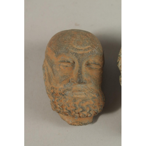 149 - A GROUP OF THREE INDIAN GANDHARA CARVED HEADS, buddha 9.5cm high, (3).